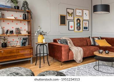 Vintage black poufs in trendy eclectic living room interior with brown couch