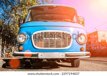 Vintage blue bus. Retro van hippie camper car on sunny street of the city. 