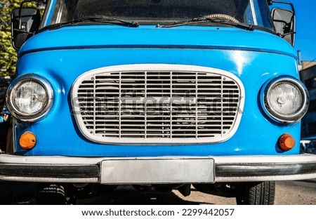 Vintage blue bus. Retro van hippie camper car on sunny street of the city. 
