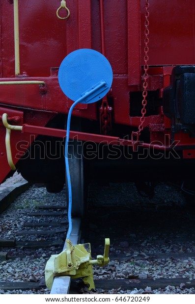 vintage blue train signal on railroad track with\
red caboose