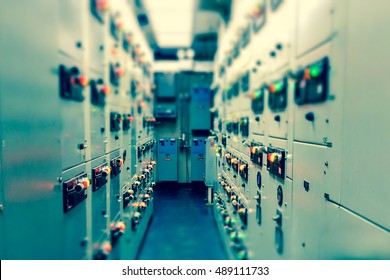 Vintage and blur tone of Electrical switchgear room,Industrial electrical switch panel on plant  and process control with grainy style.