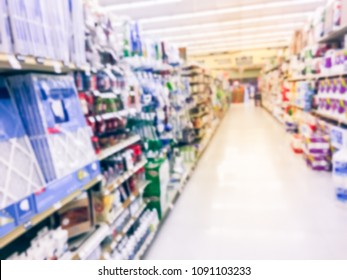 Vintage Blurred Home Cares Product On Display At Retail Store In USA. Defocused Trash Bags, Light Bulbs, Paper Tower, Air Freshener, Cup, Plate, Cleaning Supplies, Bath Tissue, School Supplies Aisle