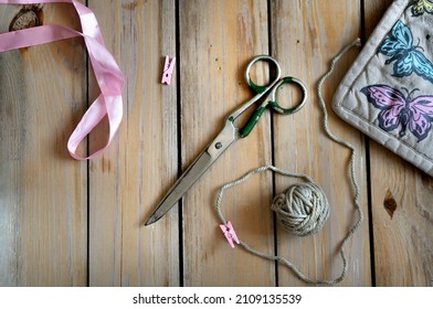 Vintage Board Background With Scissors, Ribbon And Twine. Items For Needlework, Hobbies. Top View, Flat Lay