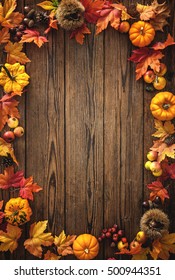 Vintage Border From Fallen Leaves And Fruits On The Old Wooden Table. Thanksgiving Autumn Background