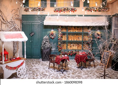 Vintage Boulangerie With Festive Decorations Covered Snow Outdoors. Cozy Bakery With Fresh Bread In Showcase At Christmas Eve. Street Food Cart, Candy Bar. Christmas And New Year Celebration Concept