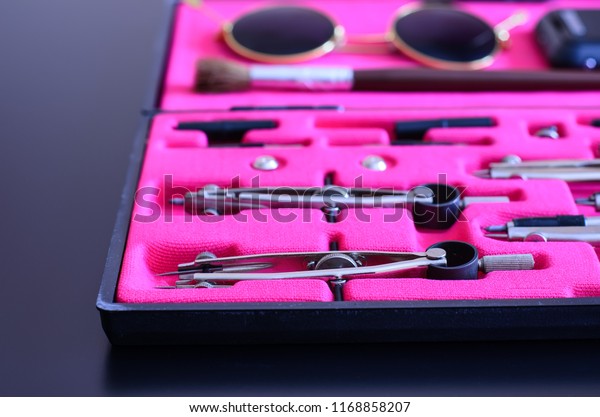 Vintage box with\
drawing tools set, sunglasses, smartphone and brush in the\
background, selective focus,\
close-up