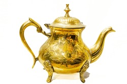 Vintage Brass Teapot Decorated With A Handcrafted Design In Relief With Tree Leaves Shape. Reflective Shining Surface Golden Colored Metal Alloy. Studio Shot Isolated In White Background. 