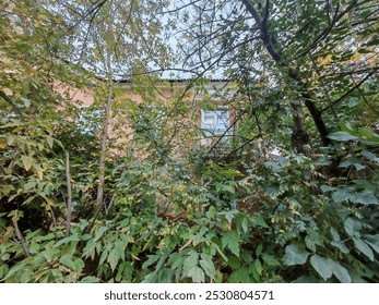 A vintage brick building with balconies and a gated entry, shaded by trees on a quiet street. The image conveys the timeless charm of urban housing, showcasing how older neighborhoods retain their - Powered by Shutterstock