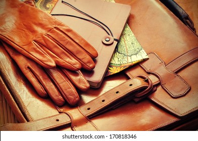 Vintage Briefcase With Leather Gloves And Old Map 