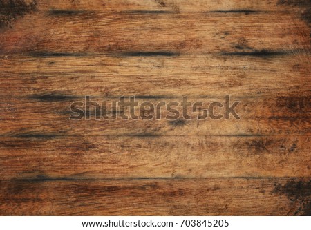 Vintage brown barrel wooden planks background texture with scratches and black stains over wood grain of old aged oak barrel bottom, close up