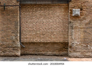 Vintage brown brick wall in alleyway of urban setting on overcast day