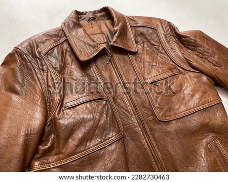 Vintage brown leather jacket on white background