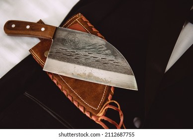 Vintage Butcher Knife With A Brown Leather Case On A Black Wedding Tuxedo