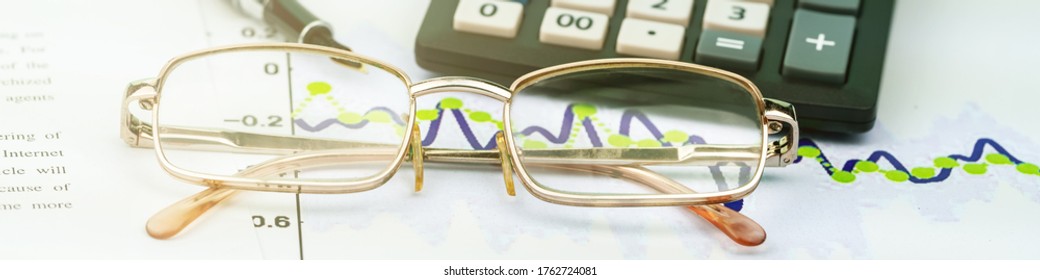 Vintage Calculator Edge With White Keys And Black Quill Tip On Sheets Of Paper Near Glasses Extreme Close View