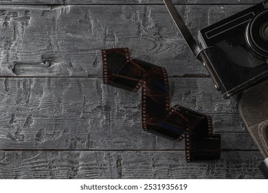 Vintage Camera and Film Reel on Rustic Wooden Surface - Powered by Shutterstock