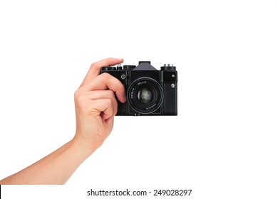 Vintage camera in hand on white background