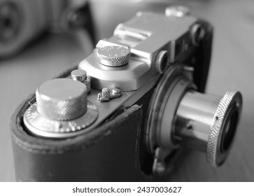 Vintage camera on the table. Selective focus. Black and white.