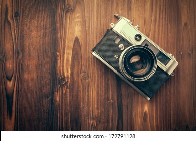 Vintage camera on wooden background