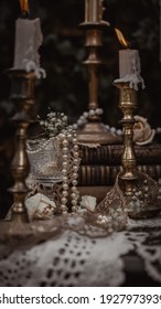 Vintage Candlesticks, Books, Glasses, Pearls, And Lace On An Old Travel Trunk