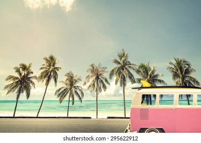 Vintage Car In The Beach With A Surfboard On The Roof