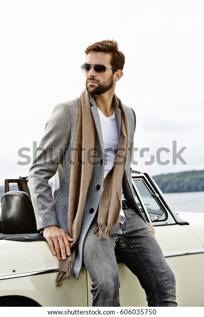 Vintage car and cool guy,\
looking away