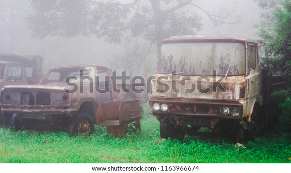 Vintage car leave it to rust. Not available. In the\
rain and mist