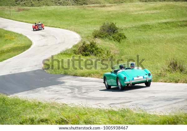 Vintage car on winding\
road