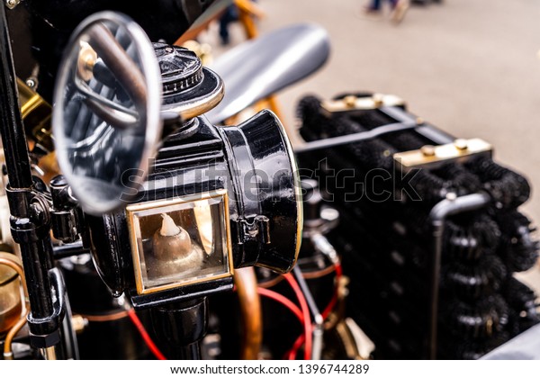 Vintage car shot with a\
low depth of field. Candle car light and side mirror with\
background bokeh, 