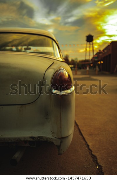 Vintage Car at sunset with\
Water Tower