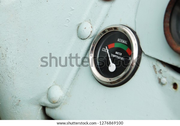 A vintage car temperature\
gauge. 