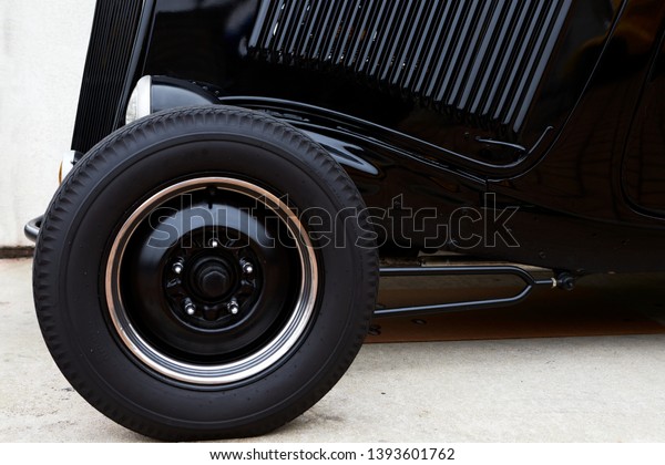 Vintage car wheel\
and front left side close-up. Side view part of old vintage rear\
car. Lines. Rear Light.