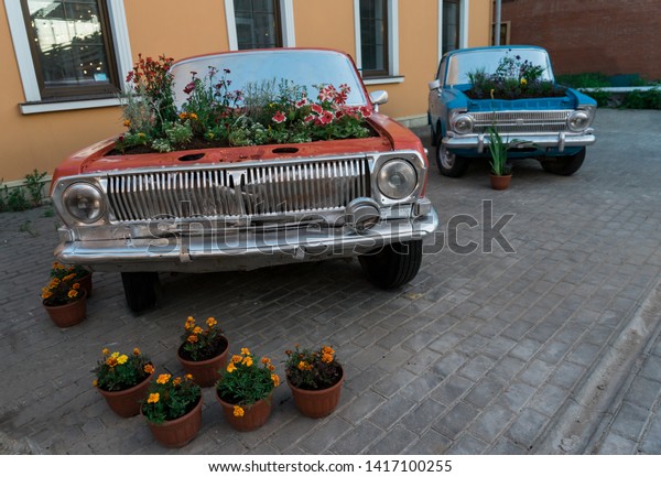 Vintage\
cars. Car in the square. The flowers in the\
car.