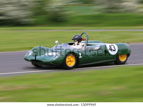 vintage cars racing\
around sprint racetrack