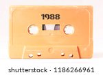 A vintage cassette tape from the 1980s era (obsolete music technology) labeled 1988 (my addition, not in the original image). Color: cream, sand. White background.
