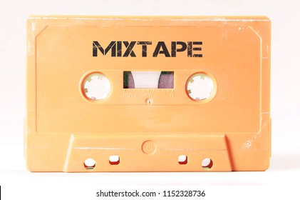 A vintage cassette tape from the 1980s era (obsolete music technology) with the text Mixtape printed over it (my addition, not in the original image). Color: cream, sand. White background.
