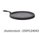 Vintage cast iron griddle. Round low frying pan with rim made of cast iron. Seasoned pan used to cook evenly on stove top and oven save. Vintage black cookware. White background. Selective focus.