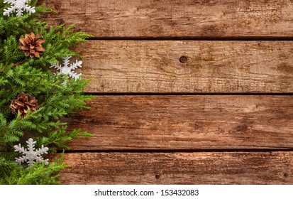 Vintage Christmas Background - Old Planked Wood Board With Pine Tree Branch, Pinecones And Silver Stars