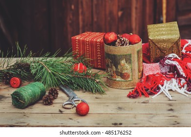 vintage Christmas decorations at wooden country house. Preparing for New Year, wrapping gifts at home, cozy rustic style - Powered by Shutterstock