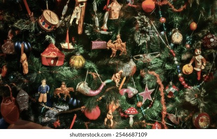 Vintage Christmas tree decorations of the late 19th century. Christmas tree with many ornaments including a clock, a horse, and a man. - Powered by Shutterstock