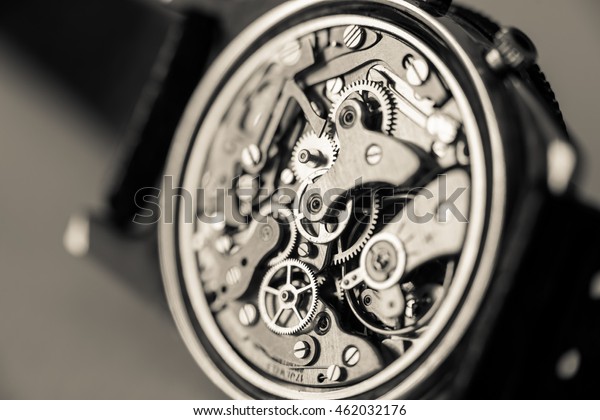 Vintage\
chronograph watch movement close-up. Sepia\
tone.