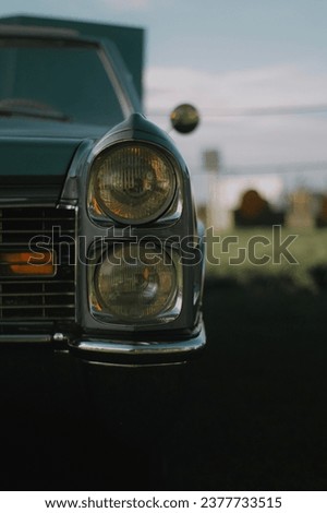 Vintage classic Chevrolet car front view with headlights, blurred background captured in Denmark 