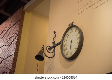 Vintage clock and bell on wall