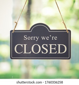 Vintage close sign board. Text written Sorry we're closed sign hanging front of cafe mirror door. Business service and food drink concept. Vintage tone filter effect. - Shutterstock ID 1760336258