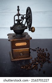 Vintage Coffee Grinder With Beans On Dark Black And Shiplap Background.