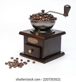 Vintage coffee grinder with coffee beans on a white background