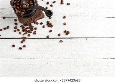 Vintage coffee grinder with beans on white wooden table with copyspace. Top view - Powered by Shutterstock