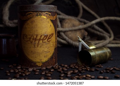 Vintage Coffee Tin Canister and Grinder With Coffee Beans On a Rustic Background