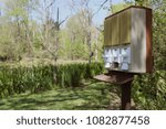 Vintage Coin Machine in front of a Pond