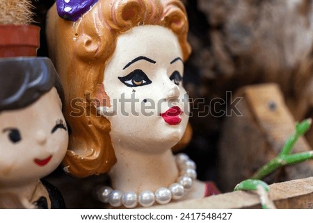 Vintage collectible women dolls' heads at an antiques market.