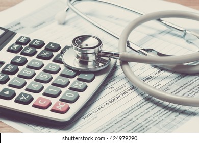 Vintage color of Health care costs. Stethoscope and calculator symbol for health care costs or medical insurance